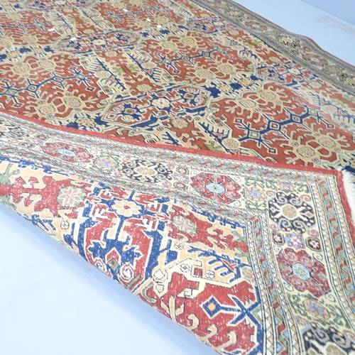 2305 - A cream-ground Kerman rug. 232x165cm