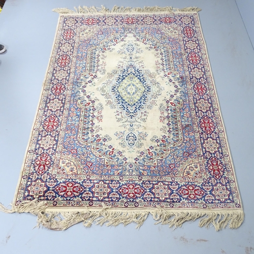 2307 - A cream-ground Kerman rug. 220x140cm