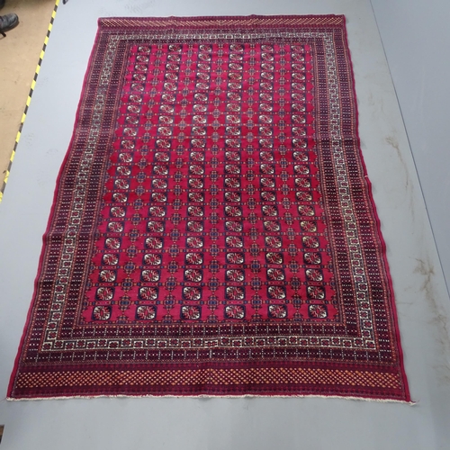 2309 - A red-ground Bokhara rug. 275x185cm.