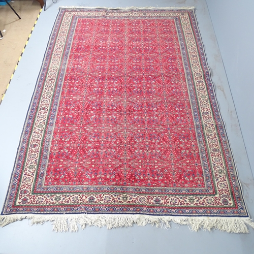 2310 - A red-ground Sarouk carpet. 295x200cm