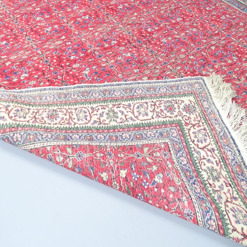 2310 - A red-ground Sarouk carpet. 295x200cm