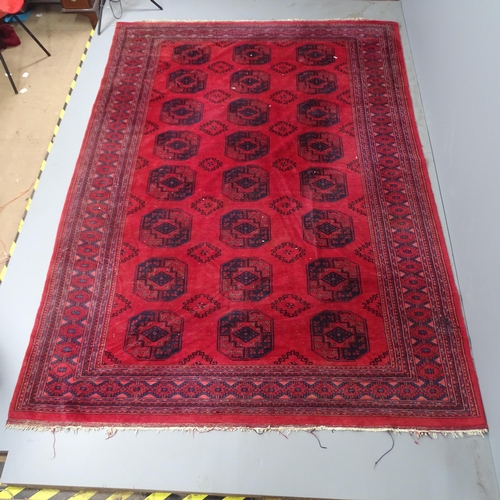 2314 - A red-ground Bokhara carpet. 308x220cm.