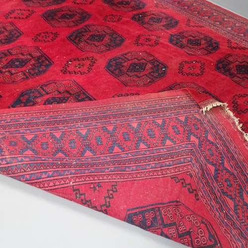 2314 - A red-ground Bokhara carpet. 308x220cm.