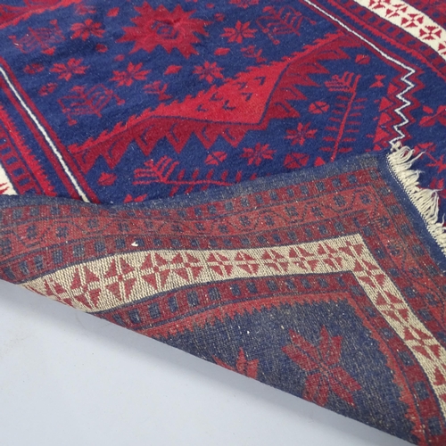 2315 - A red and blue-ground Turkish rug. 200x113