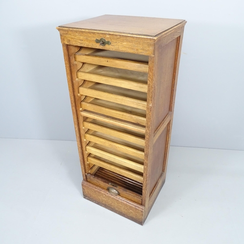 2323 - A tambour front music / filling cabinet. 46x110x39cm. With key.