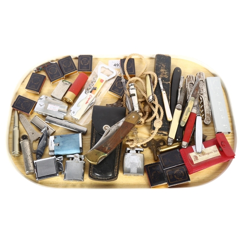 492 - A collection of penknives, pocket lighters, Vintage whistle, bottle openers etc