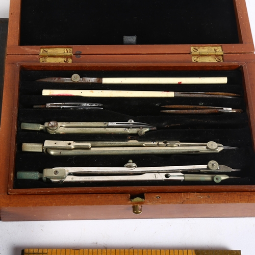 543 - 2 cased sets of draughtsman's instruments, and 5 folding Rabone rules