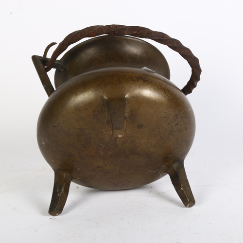 554 - A bronze cauldron with wrought-iron swing handle, diameter 17cm