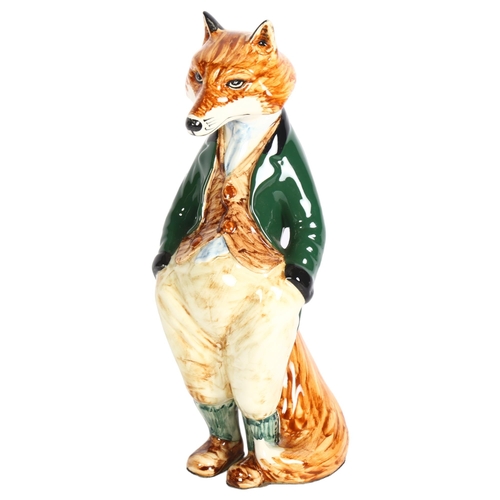 652 - Cinque Ports Pottery fox wearing a green jacket, 23cm