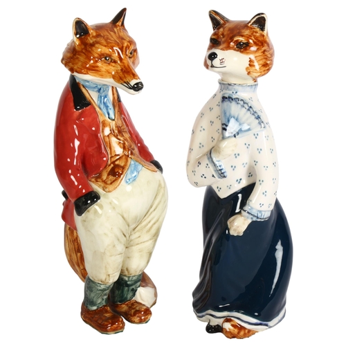 653 - Cinque Ports Pottery fox with red jacket, and female fox, H22cm