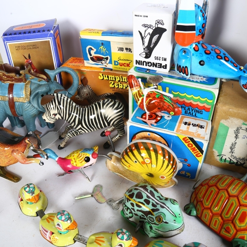 748 - A quantity of Vintage clockwork and wind-up tin toys, mostly in original boxes, including a jumping ... 