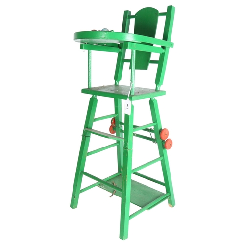 770 - A Vintage green doll's high-chair, the chair does fold down into a lower-seated position, height ful... 