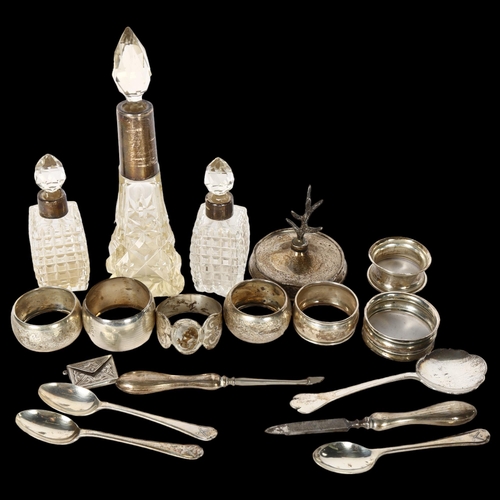 1009 - A group of silverware, to include 3 silver-mounted scent bottles, 7 silver napkin rings, silver teas... 