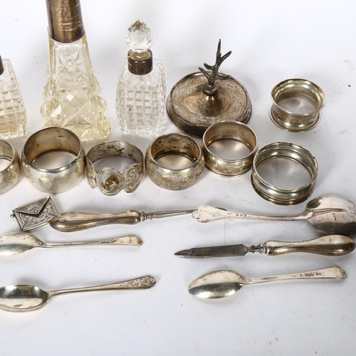 1009 - A group of silverware, to include 3 silver-mounted scent bottles, 7 silver napkin rings, silver teas... 