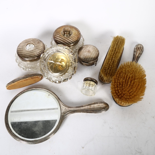 1020 - A George V silver-mounted suite of dressing table items, including powder bowls, brushes and hand mi... 