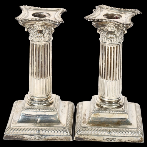 1028 - A pair of George V silver Corinthian column candlesticks, on stepped plinth bases, H15cm, hallmarks ... 