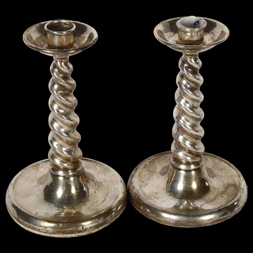 1031 - A pair of George V silver candlesticks, with spiral turned columns and shallow bases, H16.5cm, hallm... 