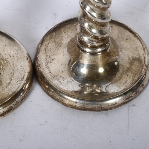 1031 - A pair of George V silver candlesticks, with spiral turned columns and shallow bases, H16.5cm, hallm... 