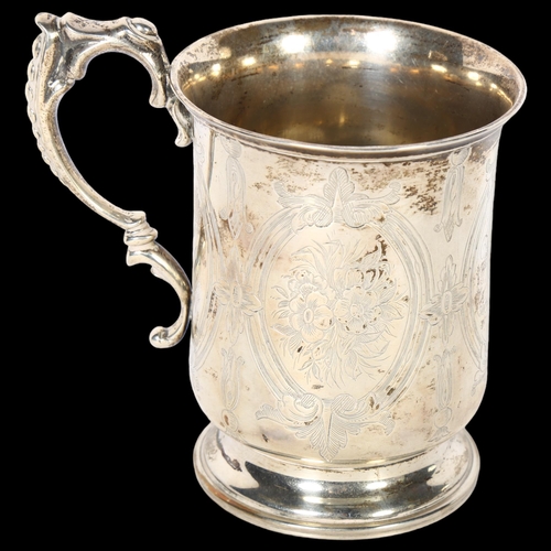 1041 - An ornate Victorian silver tankard on turned foot, with engraved decoration, with monogram HHR and d... 