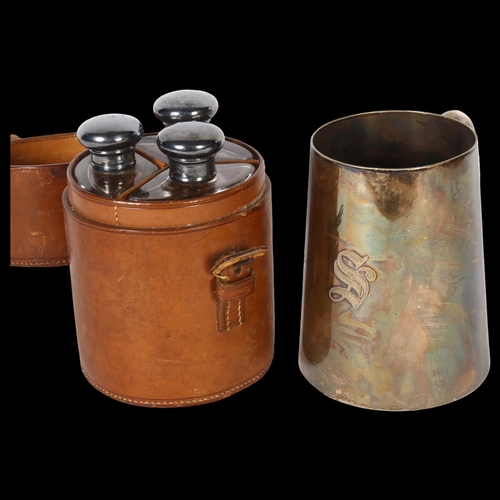 910 - A silver plated tankard, and a leather-cased travelling set comprising 3 bottles with plated lids (2... 