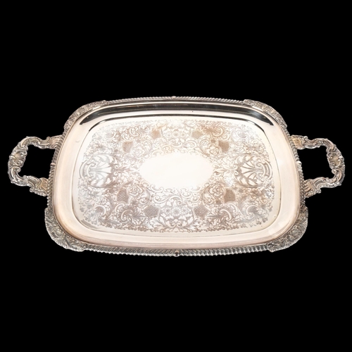 915 - An electro silver plated on copper rectangular 2-handled serving tray, with cast edge and engraved d... 