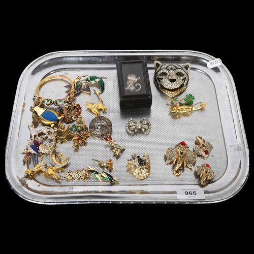 965 - A collection of ornate gilt-metal and stone set brooches, mainly in animal form, including elephants... 