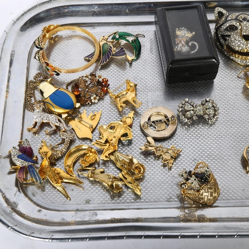 965 - A collection of ornate gilt-metal and stone set brooches, mainly in animal form, including elephants... 