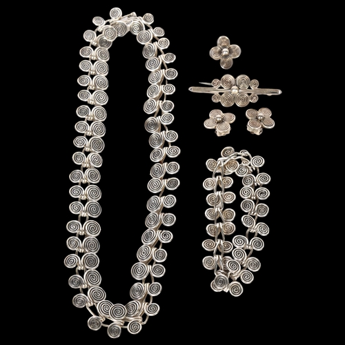 969 - A demi-parure of silver and white metal spiral design jewellery, to include a necklace, bracelet, br... 