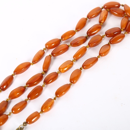 971 - A single strand butterscotch amber barrel bead necklace, overall length 72cm, bead length 18mm, 20.6... 