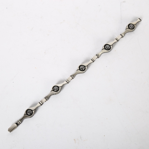 987 - KARL LAINE, FINNISH - an eye design sterling silver and cubic zirconia set panel bracelet