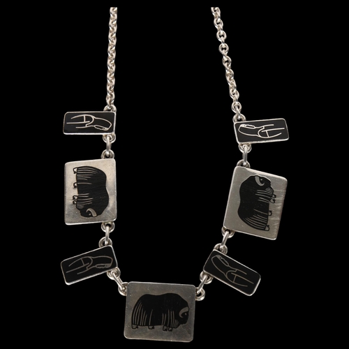 991 - JENS TAGE HANSEN - a sterling silver and black enamel bison and Inuit design panel fringe necklace