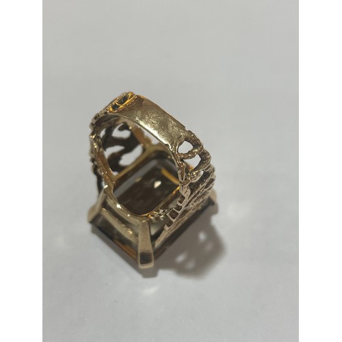 1167 - A large 1970s smoky quartz dress ring, unmarked 9ct gold settings with pierced and textured bark des... 