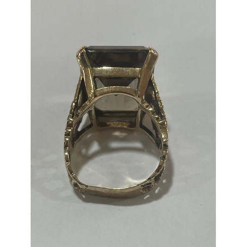 1167 - A large 1970s smoky quartz dress ring, unmarked 9ct gold settings with pierced and textured bark des... 