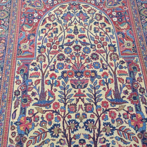 2311 - A blue and red-ground Persian prayer rug. 216x130cm