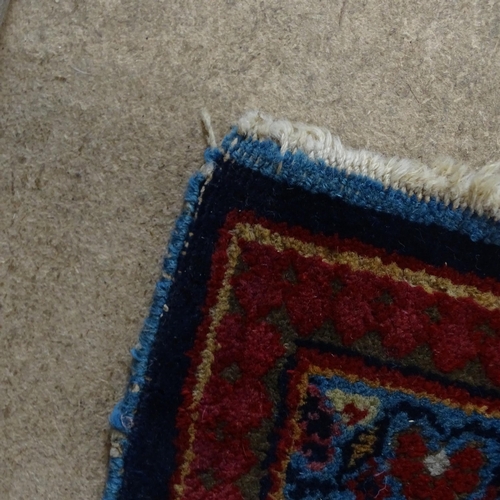 2311 - A blue and red-ground Persian prayer rug. 216x130cm