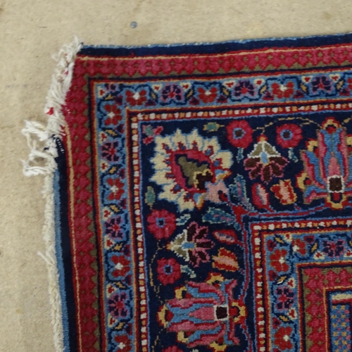 2311 - A blue and red-ground Persian prayer rug. 216x130cm