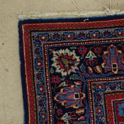 2311 - A blue and red-ground Persian prayer rug. 216x130cm