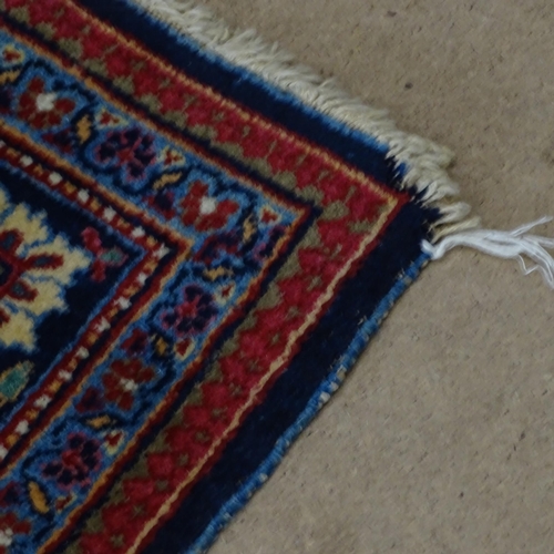 2311 - A blue and red-ground Persian prayer rug. 216x130cm