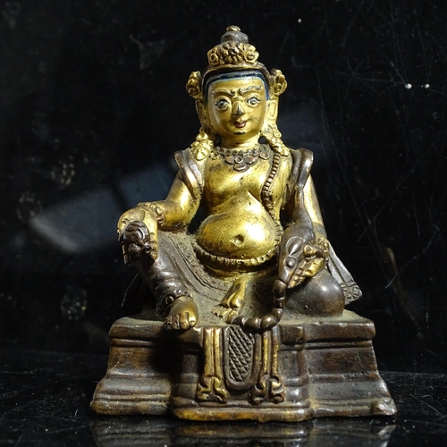 123 - A small Tibetan patinated bronze Jambhala, H9cm