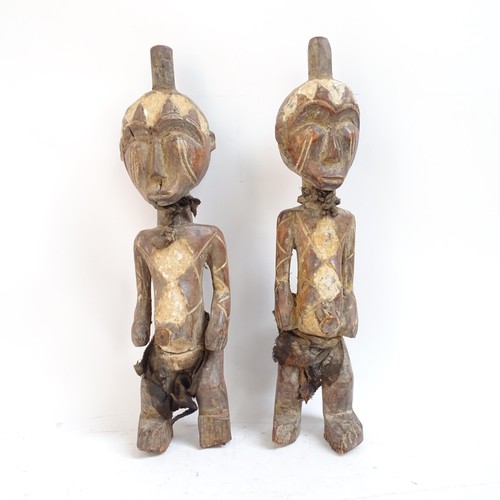 24 - A pair of West African carved wood figures, tallest 44cm
