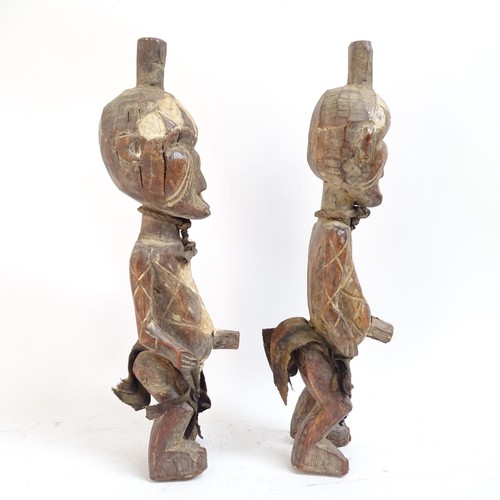 24 - A pair of West African carved wood figures, tallest 44cm