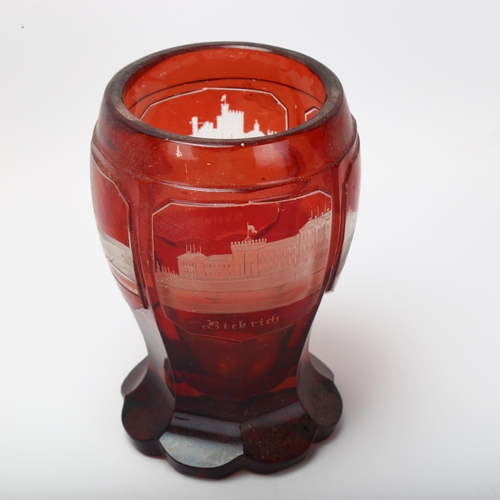 11 - 2 pieces of Bohemian glass, comprising a ruby overlay goblet with panels depicting German palaces, h... 