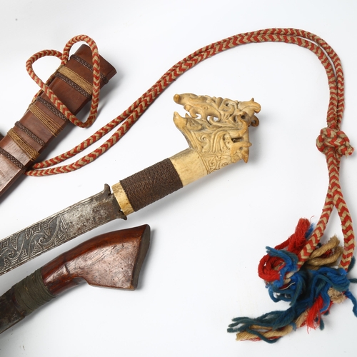 13 - 2 Mandau Dayak Borneo swords, circa 1900, 1 with elaborate carved handle, both with original wooden ... 