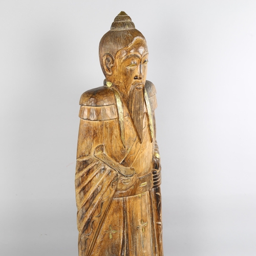 145 - A large floor standing carved and gilded wood Chinese standing Sage figure, height 119cm (3'11