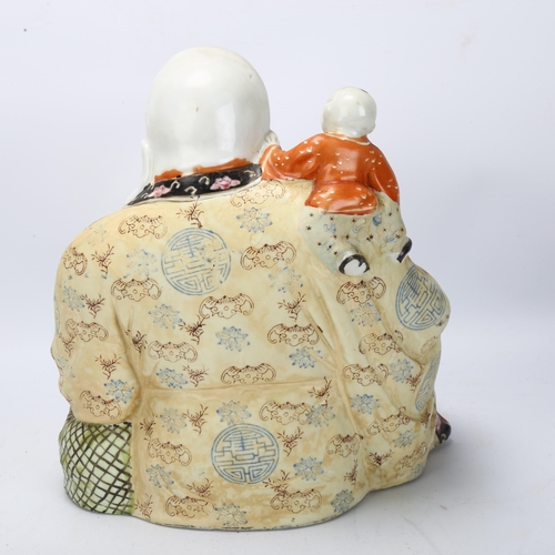 154 - A Chinese porcelain Buddha with child on his shoulders, height 26cm