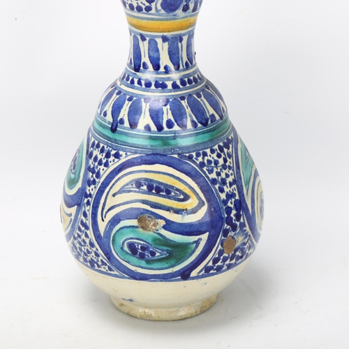 176 - A Middle Eastern pottery double-gourd vase, with blue painted decoration, height 29cm