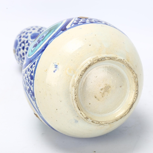 176 - A Middle Eastern pottery double-gourd vase, with blue painted decoration, height 29cm