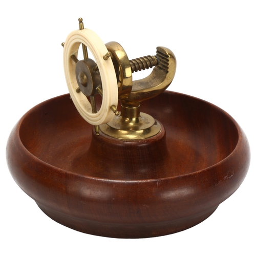 19 - An Art Deco novelty ship's wheel design combination nut bowl and cracker, mahogany brass and Bakelit... 