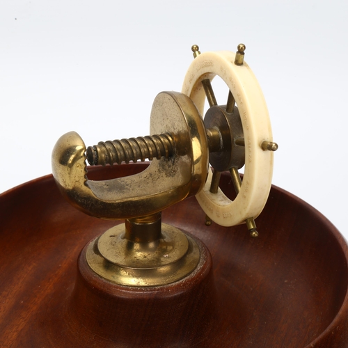 19 - An Art Deco novelty ship's wheel design combination nut bowl and cracker, mahogany brass and Bakelit... 