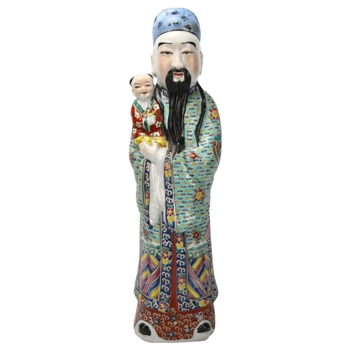 192 - A Chinese porcelain standing figure with child, height 46cm